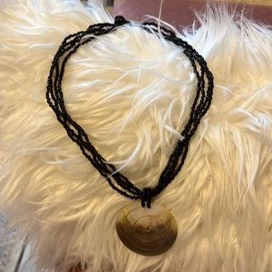 Shell necklace with black beads.